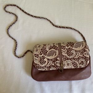 Super cute lace and leather purse. Strap can be removed for a clutch.